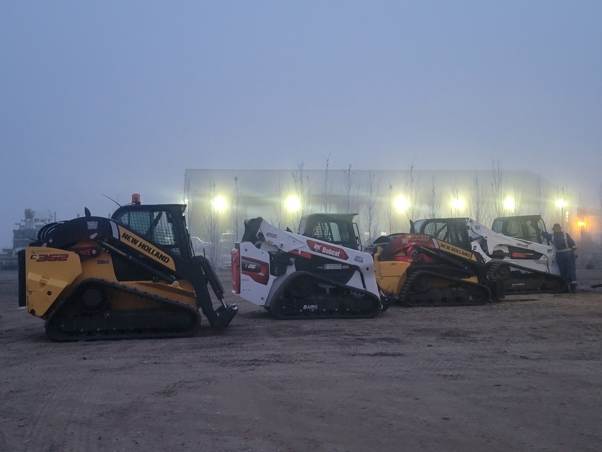 Shmittys Shwabbin Skidsteers lined up in yard